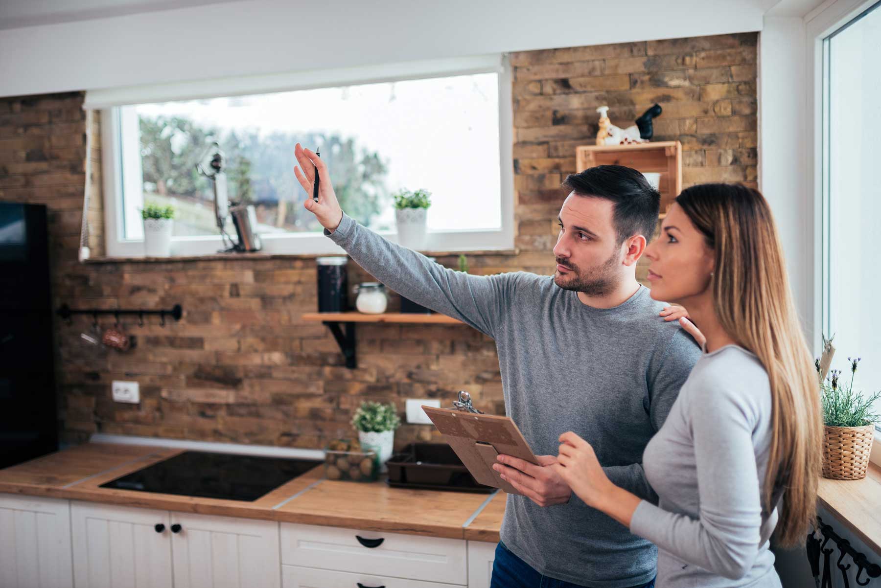 An inspector pointing out something to a female customer